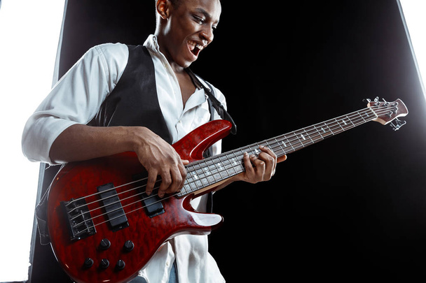 African American jazz musician playing bass guitar. - Foto, afbeelding
