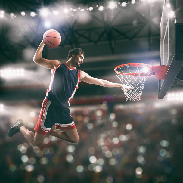 Acrobatic slam dunk koszykarza w koszyku na stadionie - Zdjęcie, obraz