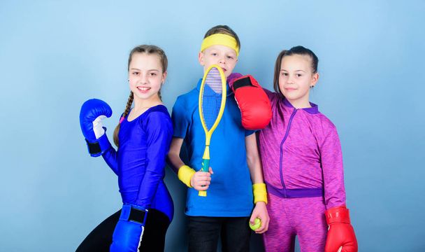 Born to fight. Happy children in boxing gloves with tennis racket and ball. Fitness energy health. punching knockout. Team sport success. workout of small girls boxer and boy in sportswear - Foto, afbeelding