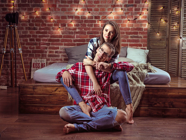Portrait of a relaxed cheerful couple in a modern interior - Photo, Image