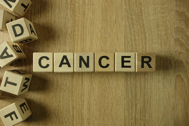 Cancer word from wooden blocks on desk - Фото, изображение