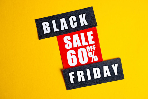 Black Friday sale concept. Sixty percent discount. Sale sticker on yellow background. - Фото, изображение