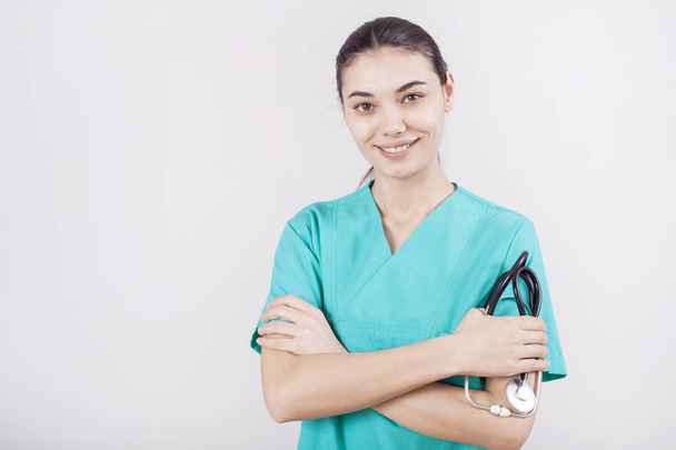 Young woman doctor portrait on gray background - Valokuva, kuva