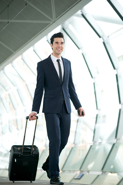 Young businessman traveling with bag - Фото, изображение