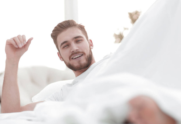 closeup.smiling man resting in the bedroom - Φωτογραφία, εικόνα