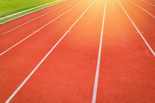 Athletics Track Run / Red running track in stadium with green fi - 写真・画像