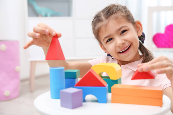 Cute child playing with colorful blocks at home - Photo, Image