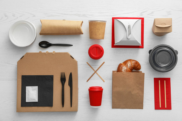 Flat lay composition with paper bag and different takeaway items on wooden background. Space for design - Foto, Imagem