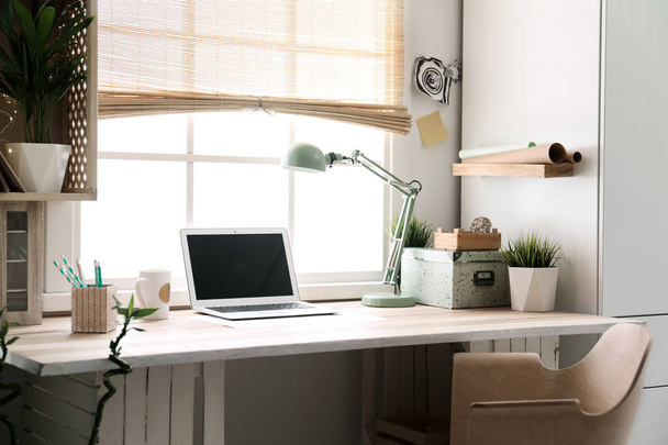 Modern home workplace with wooden crates. Eco style interior - 写真・画像