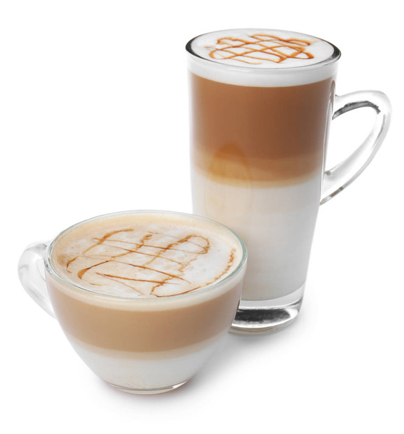 Glass cups of tasty caramel macchiato on white background - 写真・画像
