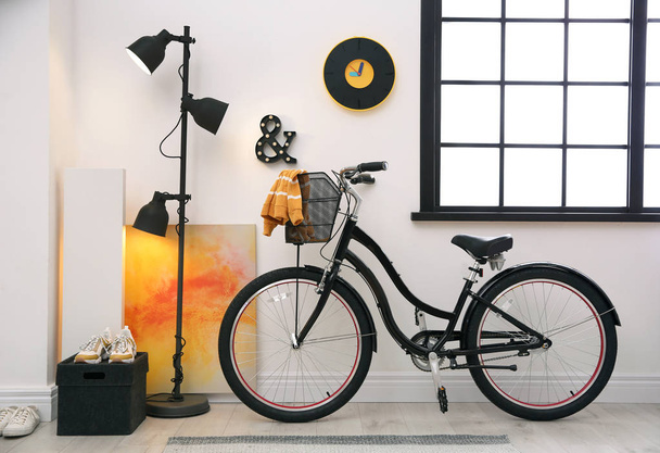 Stylish room interior with modern bicycle. Hipster design - 写真・画像
