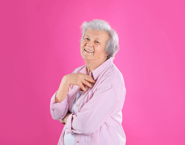 Portrait of grandmother in stylish clothes on color background - Φωτογραφία, εικόνα