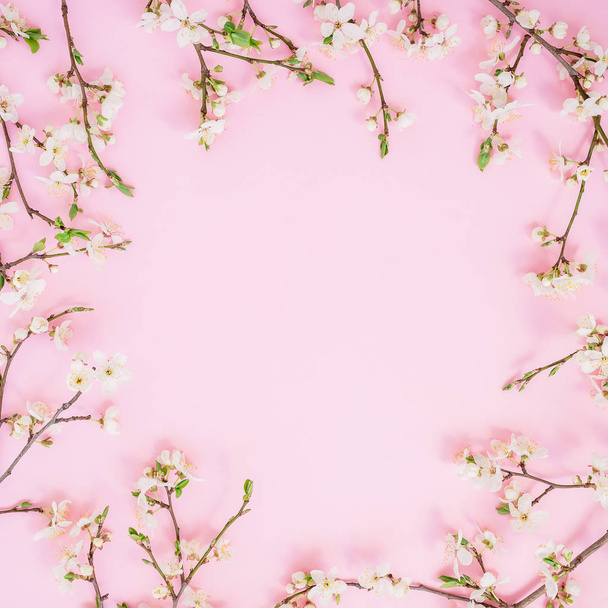 Floral frame of spring flowers isolated on pink background. Flat lay, top view - Φωτογραφία, εικόνα