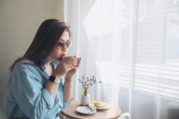 Portrait happy young Asian lady in coffee shop - woman in relax time concept - 写真・画像