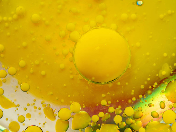 Yellow glittering spheres on abstract background. Close up macro shot. Blurred background. Selective soft focus. Universe of glittering yellow bubbles. Abstract paint pattern. - Photo, image