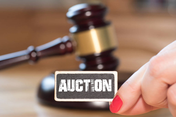 An auction hammer, a woman and a sign auction - 写真・画像