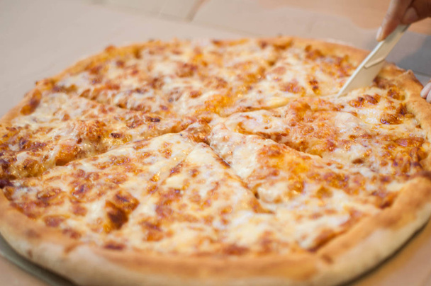 Egy egész négy sajtos pizza egy étkezőasztal - Fotó, kép