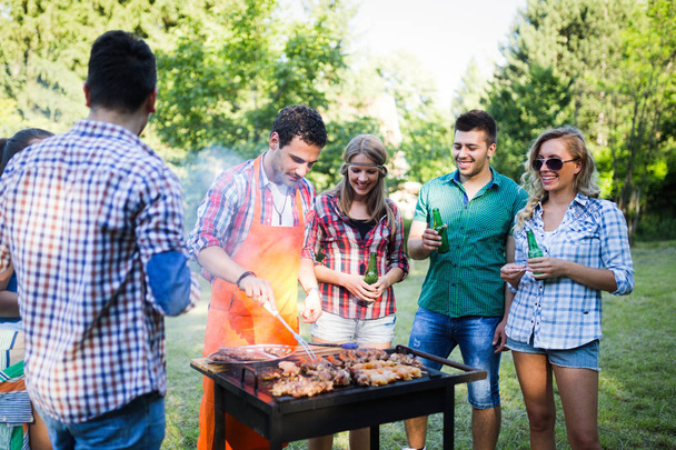 Friends having barbecue party in nature - Foto, immagini