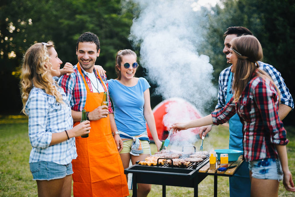 Friends having barbecue party in nature - Foto, Bild