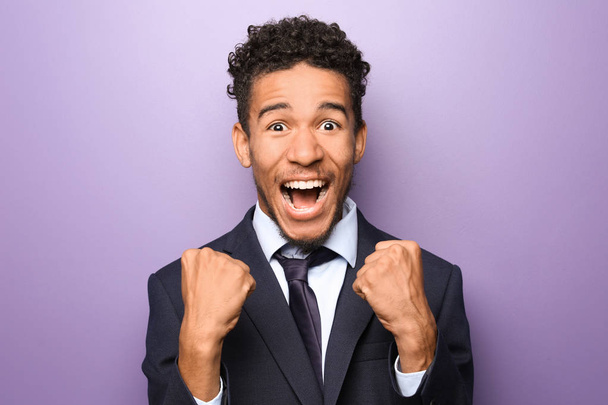 Portrait of happy African-American businessman on color background - Fotó, kép