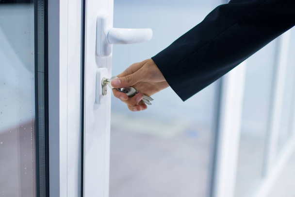 hand at the entrance door or access, lock and security - 写真・画像