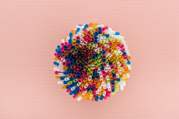 top view of colorful and bright plastic straws isolated on pink - Photo, image