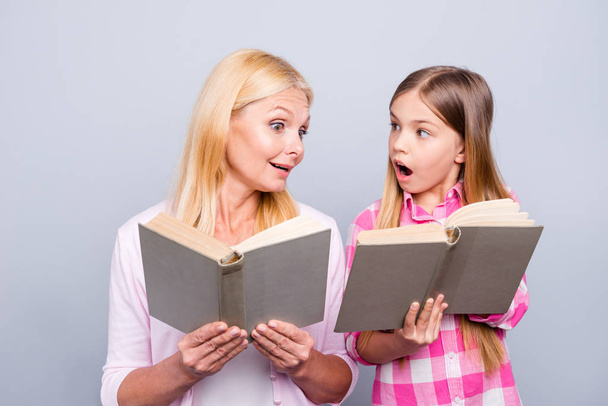 Close up photo adorable friendly blond hair she her grandma little granddaughter hold reading books share impressions feelings wear casual pink plaid checkered shirt sweater isolated grey background - Φωτογραφία, εικόνα