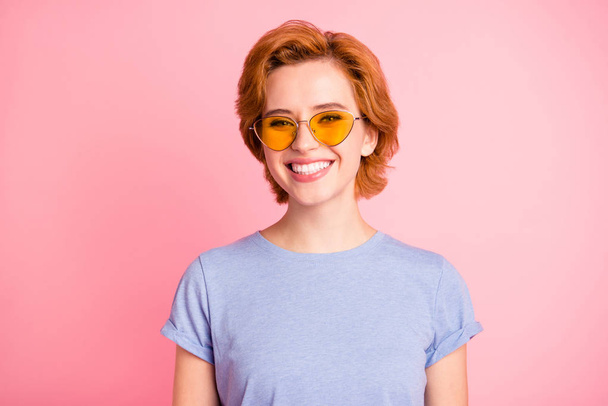 Close-up portrait of her she nice cute charming attractive cheerful cheery girl wearing casual blue t-shirt yellow glasses isolated over pink pastel background - Fotoğraf, Görsel