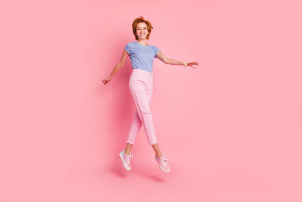 Full length body size view of her she nice cute charming attractive winsome lovely cheerful cheery feminine girl wearing casual walking on air having fun isolated on pink pastel background - Foto, Imagem