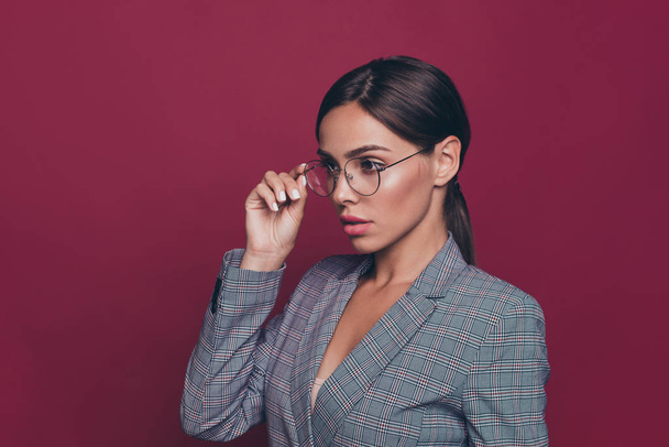 Close up side profile photo beautiful amazing business she her lady hold one hand arm specs look empty space just started career wearing formal-wear isolated dark red vivid background - Foto, Imagem