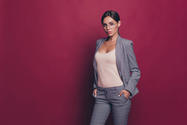 Portrait of her she nice cute attractive lovely sweet magnificent winsome shine classy content lady ceo boss chief leader wearing gray checkered suit isolated over maroon burgundy marsala background - Foto, imagen