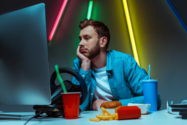 handsome and sad man touching his head and looking at computer monitor  - Photo, Image