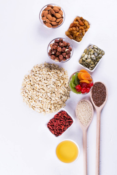 Oat flakes and various delicious ingredients for healthy breakfast, top view,  - Foto, Bild