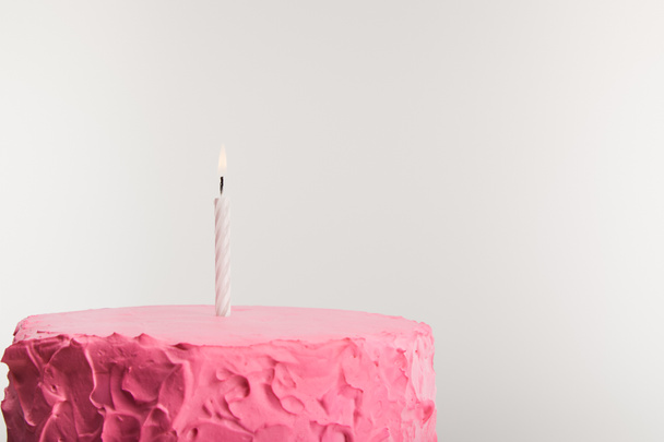 delicious pink birthday cake with candle isolated on grey - Photo, Image