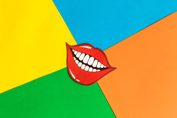 Flat lay of funny smile on multicolored background abstract. - Valokuva, kuva