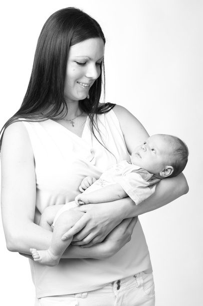 Black and White Art photo of beautiful mother holding baby boy - Zdjęcie, obraz