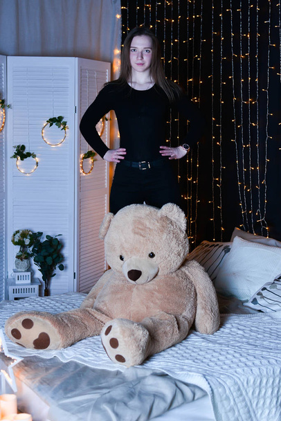 young beautiful woman posing   with big teddy bear  - Фото, зображення