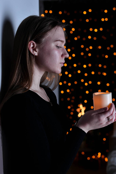 young beautiful woman posing  with candle  - Fotoğraf, Görsel
