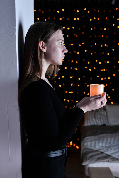 young beautiful woman posing  with candle  - Фото, изображение