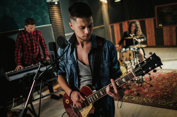 Music band having rehearsal in a studio - Photo, Image