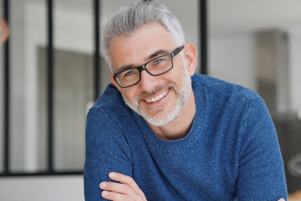 Portrait of smiling man with grey hair and glasses - 写真・画像
