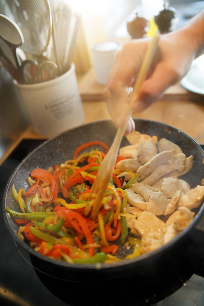 Closeup of frying pan with meat and vegetables being cooked - Фото, зображення