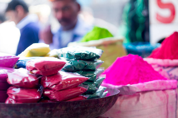 Piles and packets of gulaal color for indian festival of holi - Photo, Image