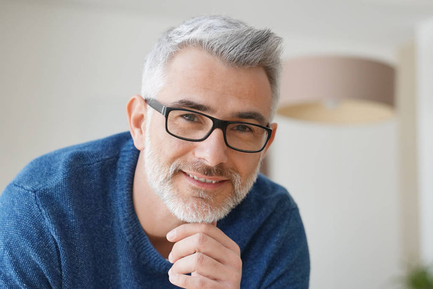 Portrait of smiling man with grey hair and glasses - Photo, image