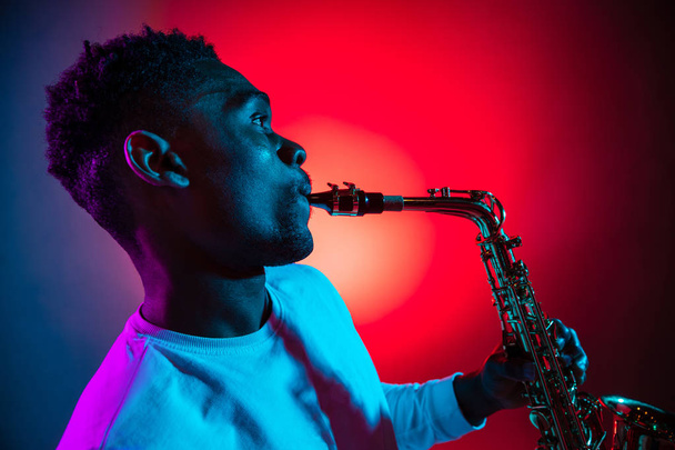 African American jazz musician playing the saxophone. - Photo, image