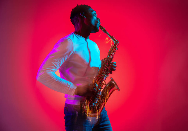 African American jazz musician playing the saxophone. - Valokuva, kuva