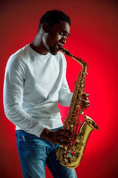 African American jazz musician playing the saxophone. - Фото, изображение