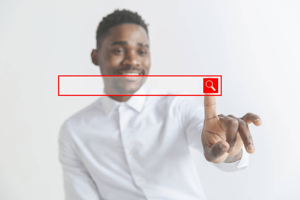 Young african american guy interacts with empty search bar. Negative space to insert your text. - Fotografie, Obrázek