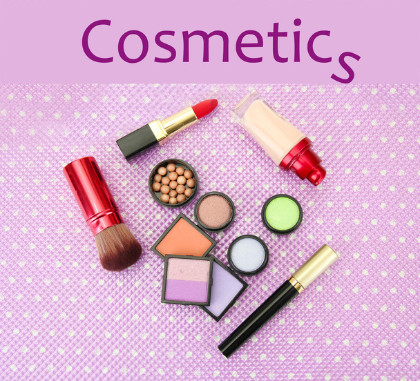 Decorative cosmetics on purple background - Foto, afbeelding