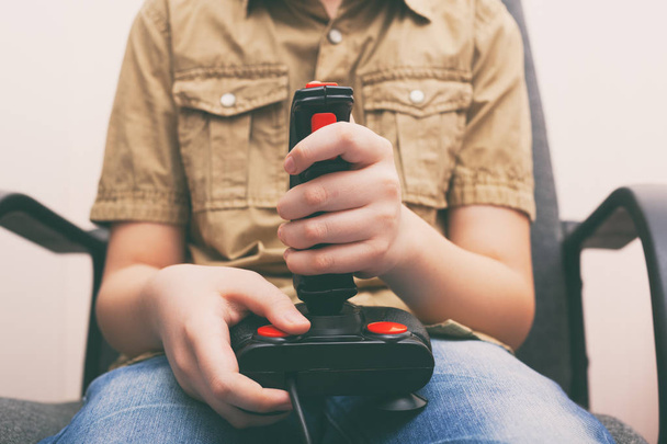 Young boy playing video game with a retro joystick - Foto, Imagem